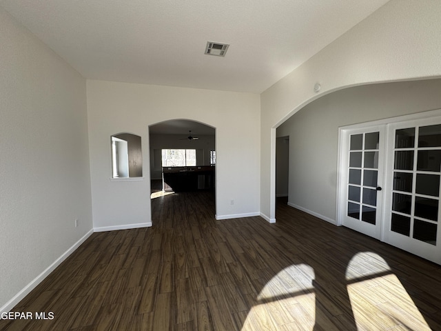 unfurnished room with ceiling fan, french doors, and dark hardwood / wood-style floors