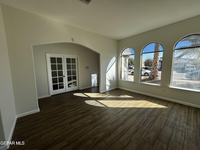 unfurnished room with dark hardwood / wood-style flooring and french doors