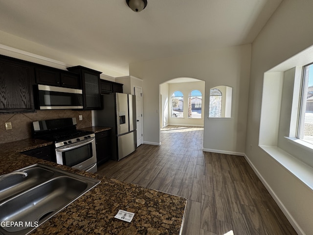 kitchen with sink, decorative backsplash, a wealth of natural light, and appliances with stainless steel finishes