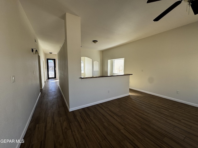 interior space featuring ceiling fan and dark hardwood / wood-style floors