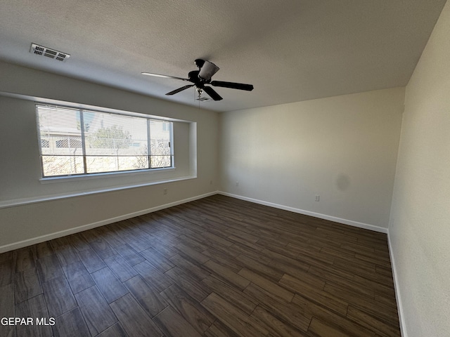 unfurnished room featuring dark hardwood / wood-style flooring, a textured ceiling, and ceiling fan