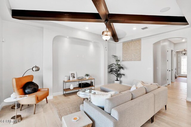 living room featuring beam ceiling, light hardwood / wood-style flooring, and coffered ceiling