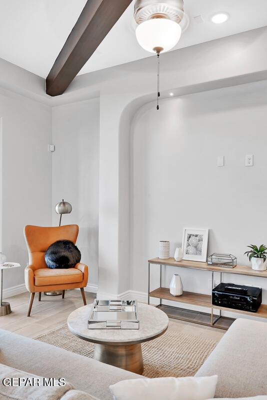 sitting room featuring beamed ceiling and light hardwood / wood-style floors