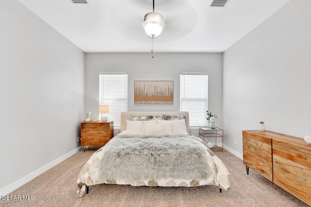 bedroom featuring ceiling fan, carpet floors, and multiple windows