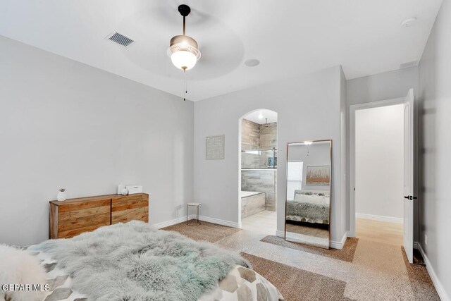 bedroom with ensuite bath and ceiling fan