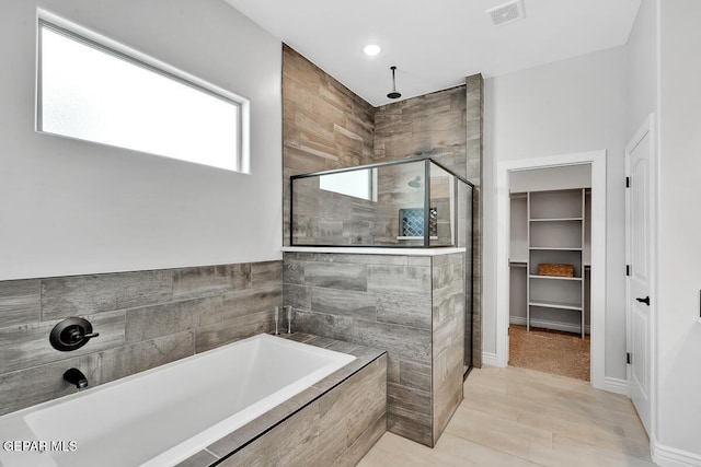 bathroom with shower with separate bathtub