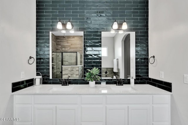 bathroom featuring vanity and a shower with door