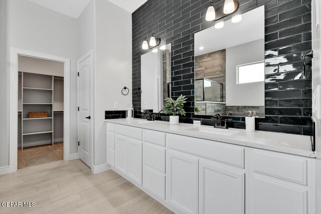 bathroom featuring hardwood / wood-style floors, vanity, and walk in shower