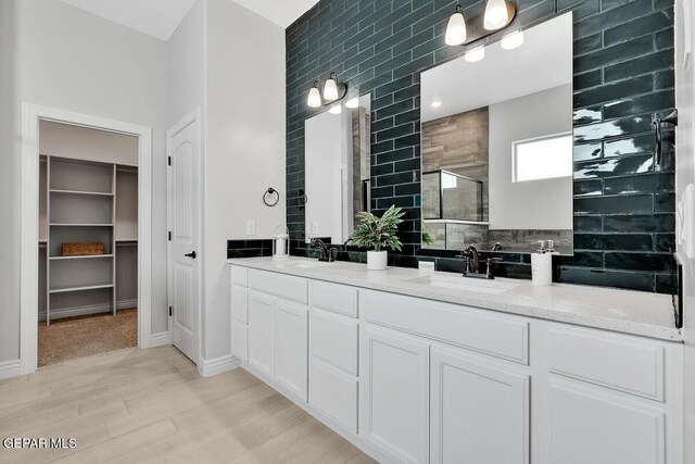 bathroom with vanity, wood-type flooring, and walk in shower