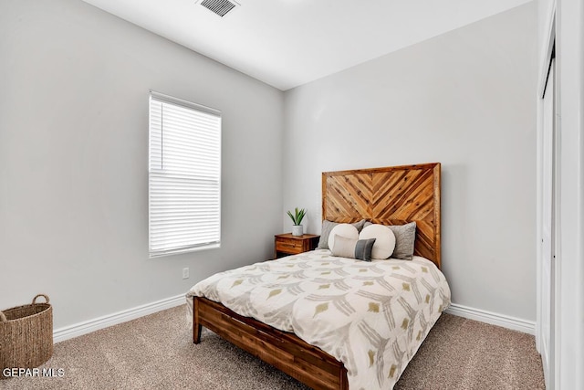 bedroom with carpet and a closet