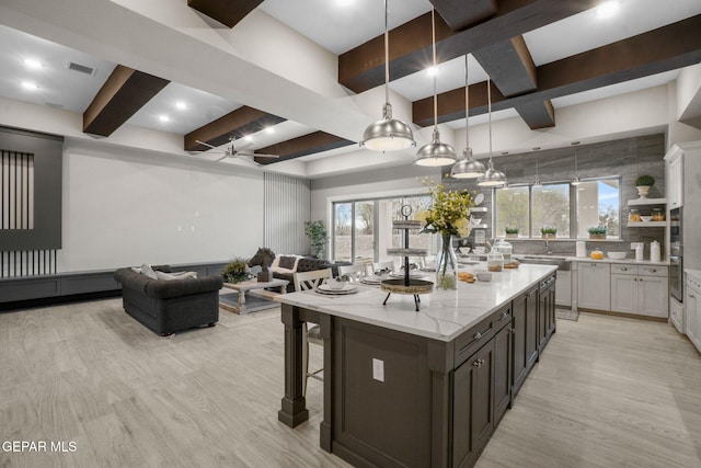 kitchen with pendant lighting, ceiling fan, and white cabinetry