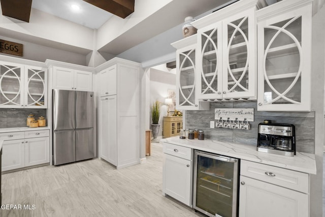 kitchen featuring white cabinetry, wine cooler, stainless steel fridge, and backsplash