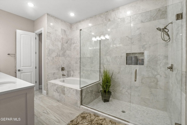 bathroom with vanity and separate shower and tub