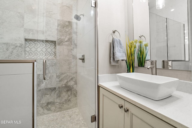 bathroom featuring vanity and an enclosed shower