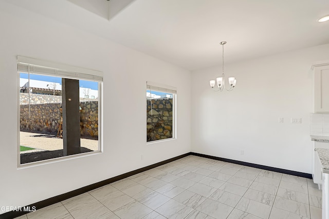 spare room with a notable chandelier