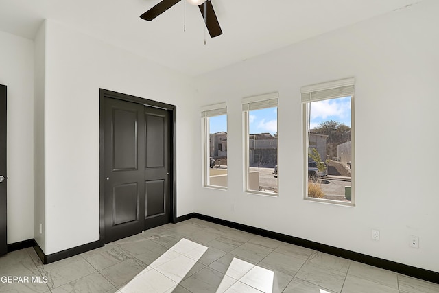 unfurnished room featuring ceiling fan and light tile patterned floors