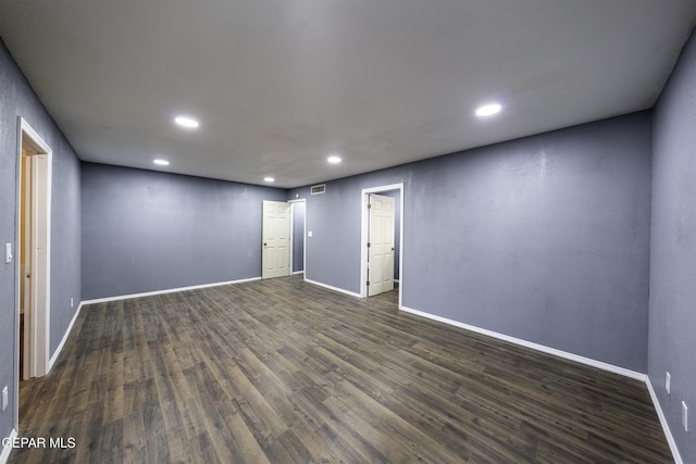 unfurnished room featuring dark hardwood / wood-style flooring