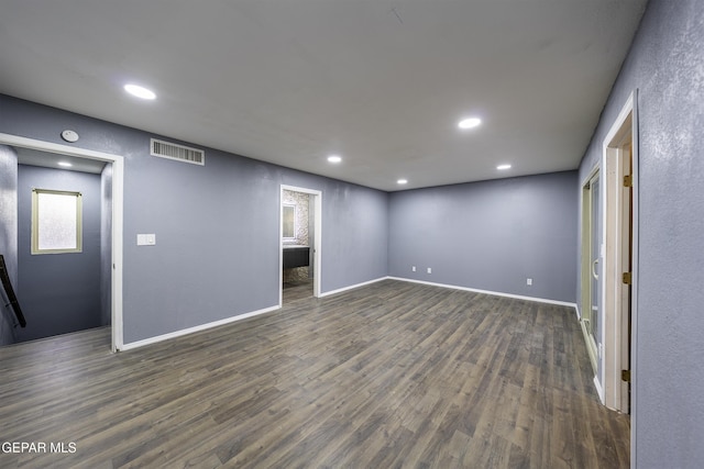 spare room with dark wood-type flooring