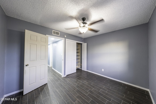 unfurnished bedroom with ceiling fan, a closet, and a textured ceiling