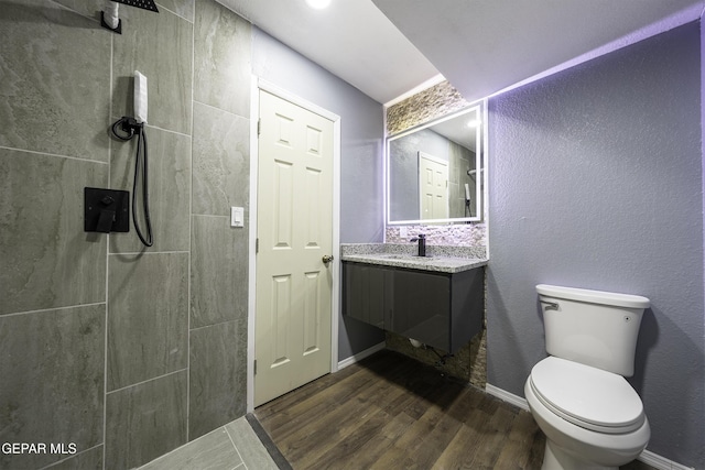 bathroom with hardwood / wood-style floors, vanity, and toilet