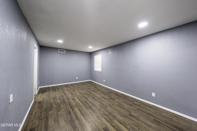 spare room featuring dark wood-type flooring