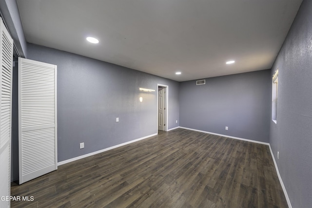 empty room with dark hardwood / wood-style flooring