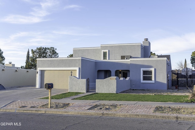 pueblo-style home with a garage