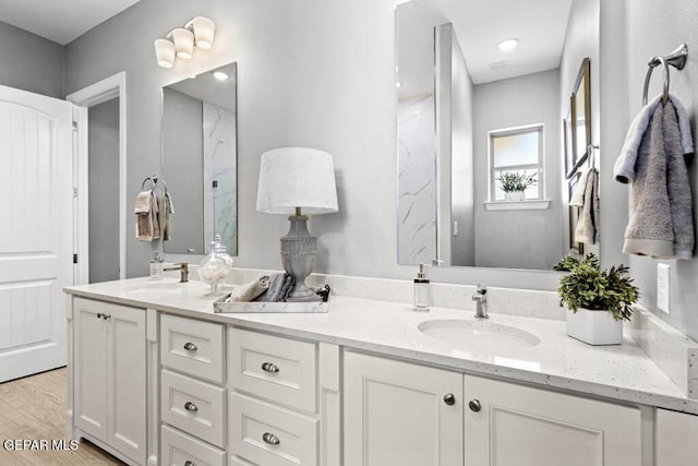 bathroom with hardwood / wood-style floors and vanity