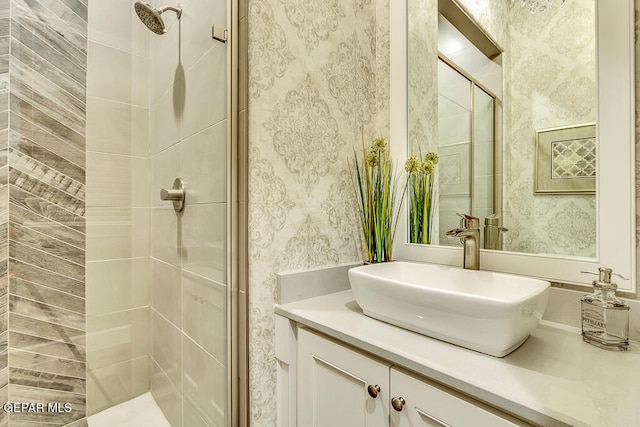 bathroom with vanity and a shower with shower door