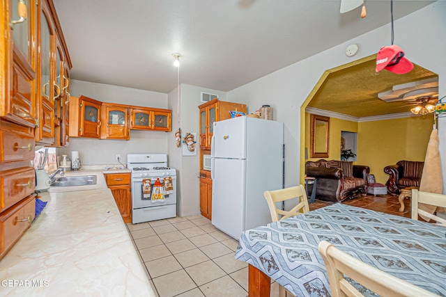 kitchen featuring ceiling fan, white appliances, sink, and light tile patterned floors