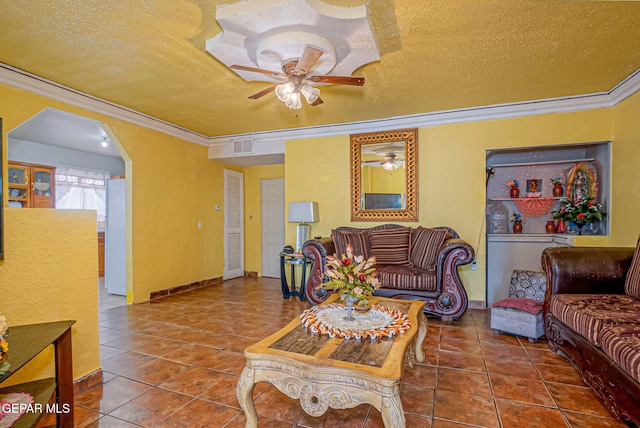 tiled living room featuring ceiling fan, crown molding, and a textured ceiling