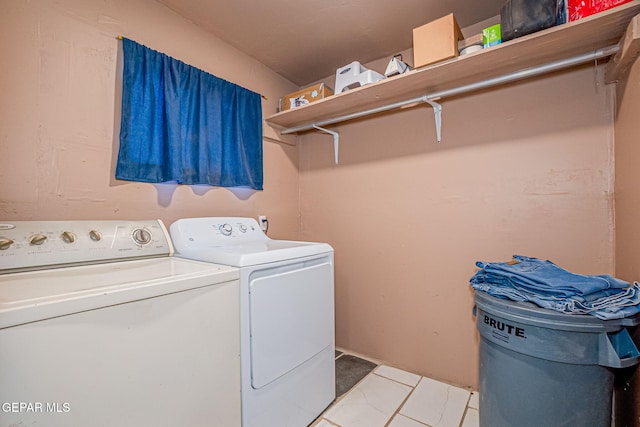 clothes washing area with separate washer and dryer and light tile patterned floors