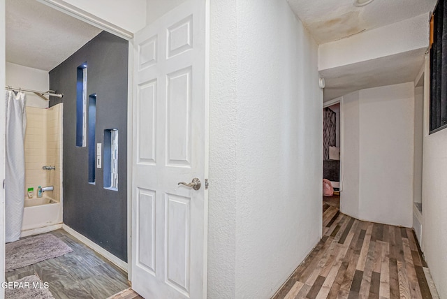 hall with hardwood / wood-style flooring