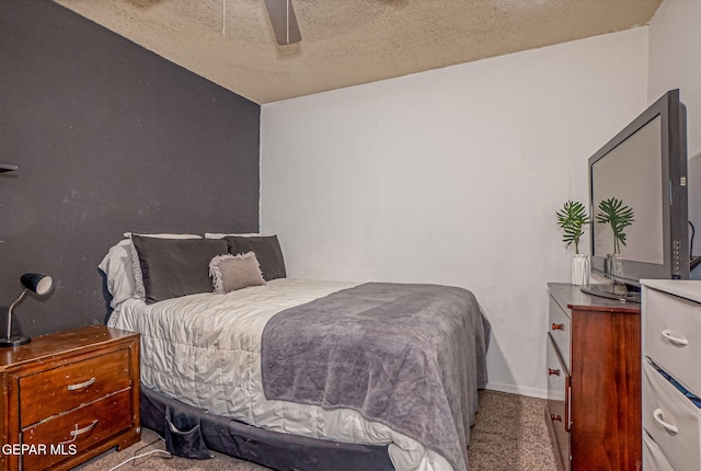 carpeted bedroom featuring a textured ceiling and ceiling fan