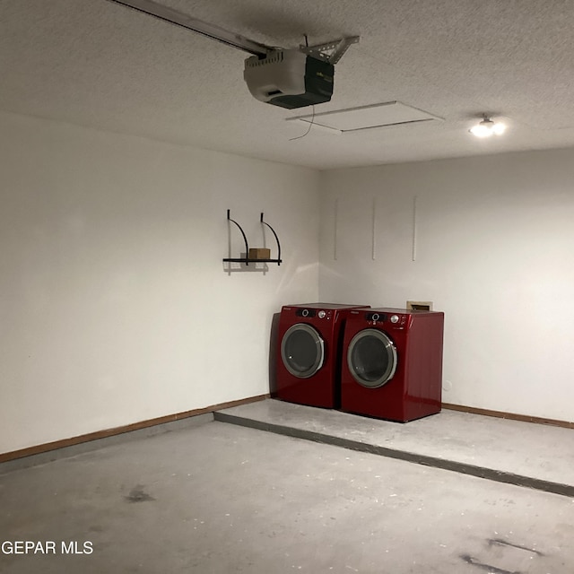 garage featuring washer and dryer and a garage door opener