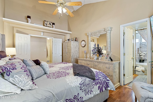 bedroom featuring hardwood / wood-style floors, ceiling fan, and lofted ceiling