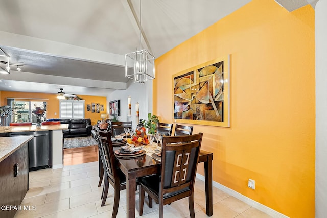 dining room with light tile patterned floors and ceiling fan with notable chandelier