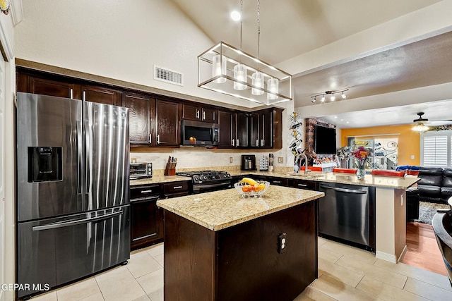 kitchen with dark brown cabinets, a kitchen island, stainless steel appliances, and hanging light fixtures