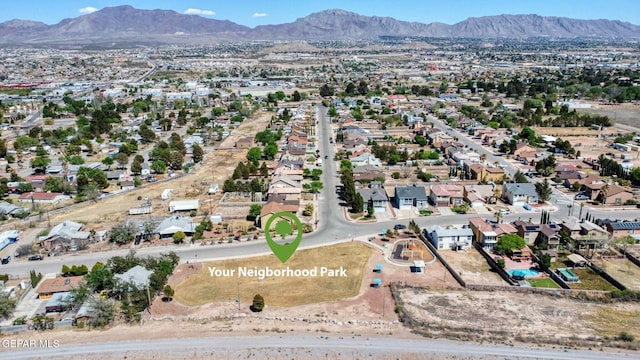 birds eye view of property with a mountain view