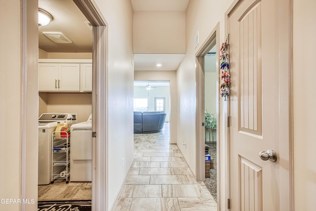 corridor with washing machine and clothes dryer