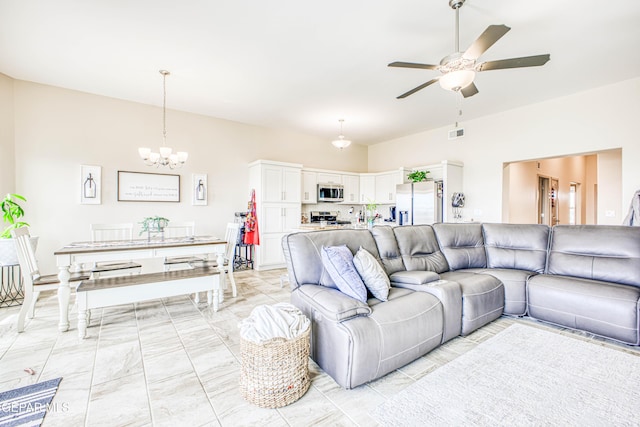 living room featuring ceiling fan with notable chandelier