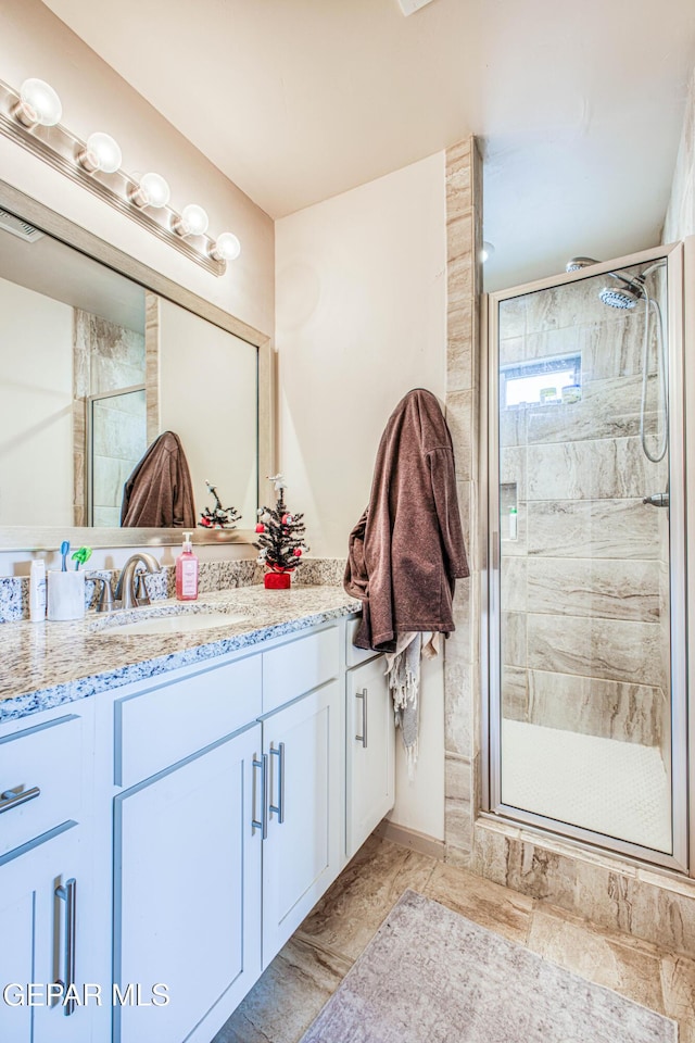 bathroom with vanity and walk in shower