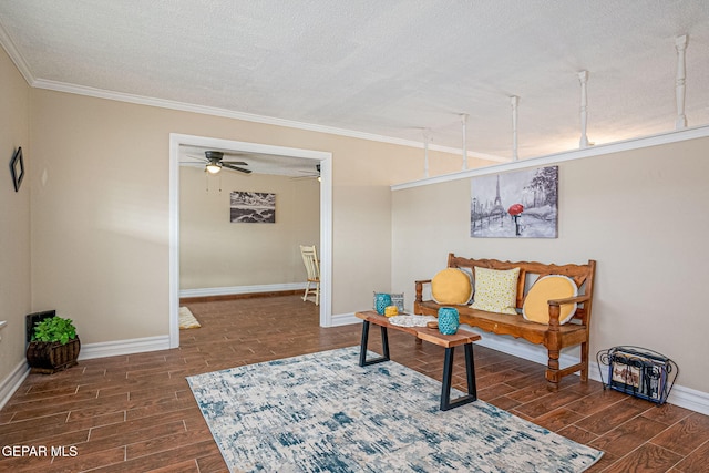 sitting room featuring a textured ceiling, ceiling fan, and ornamental molding