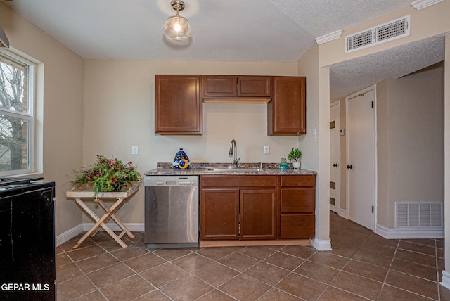 kitchen featuring stainless steel dishwasher, sink, dark tile patterned flooring, and a textured ceiling