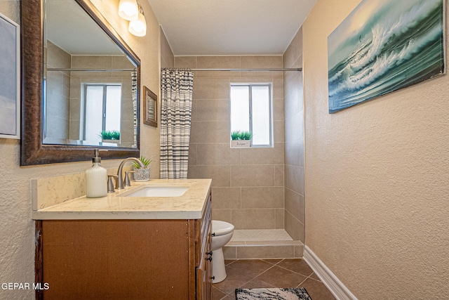 bathroom featuring tile patterned floors, vanity, curtained shower, and toilet