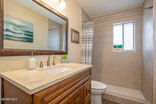 bathroom featuring vanity, toilet, and curtained shower