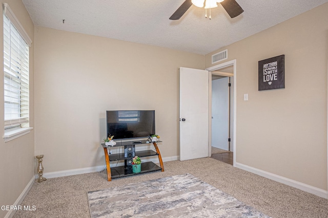 office area featuring ceiling fan, carpet floors, and a textured ceiling