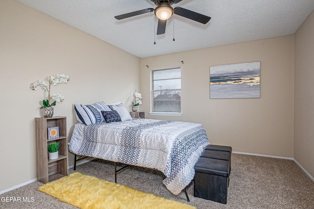 bedroom featuring carpet, ceiling fan, and a textured ceiling