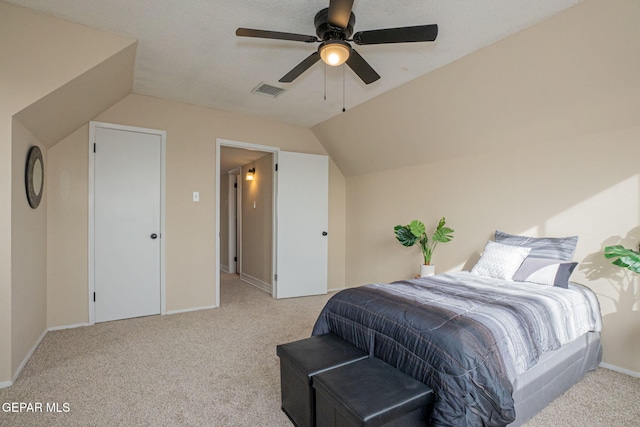 carpeted bedroom featuring a textured ceiling, ceiling fan, and lofted ceiling