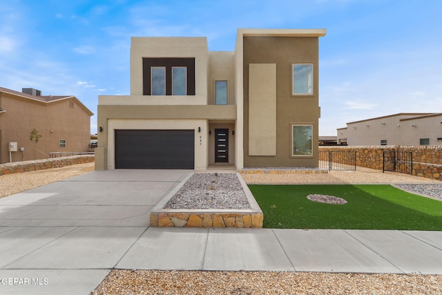 southwest-style home featuring a front lawn and a garage